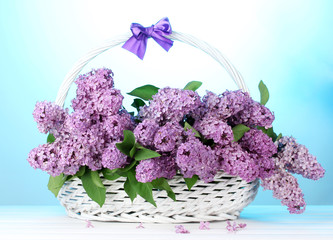 Sticker - beautiful lilac flowers in basket on blue background