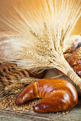 Wall Mural - fresh bread and wheat on the wooden