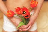 Fototapeta Tulipany - Romantic young man with flowers. Focus on flowers.