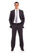 © michaeljung - young businessman studio portrait both hands in pockets