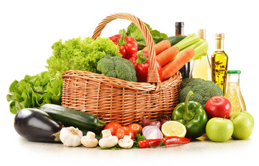 Fototapete - raw vegetables in wicker basket isolated on white