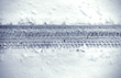Detail of car’s tire track in snow