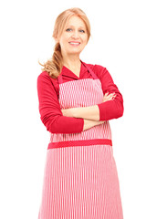 Wall Mural - Smiling female worker wearing an apron and posing