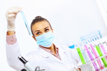 Wall Mural - Young female scientist working in laboratory