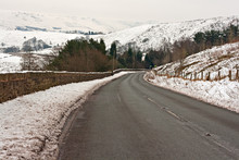 Empty Road Through Snow Covered Yorkshire Moors