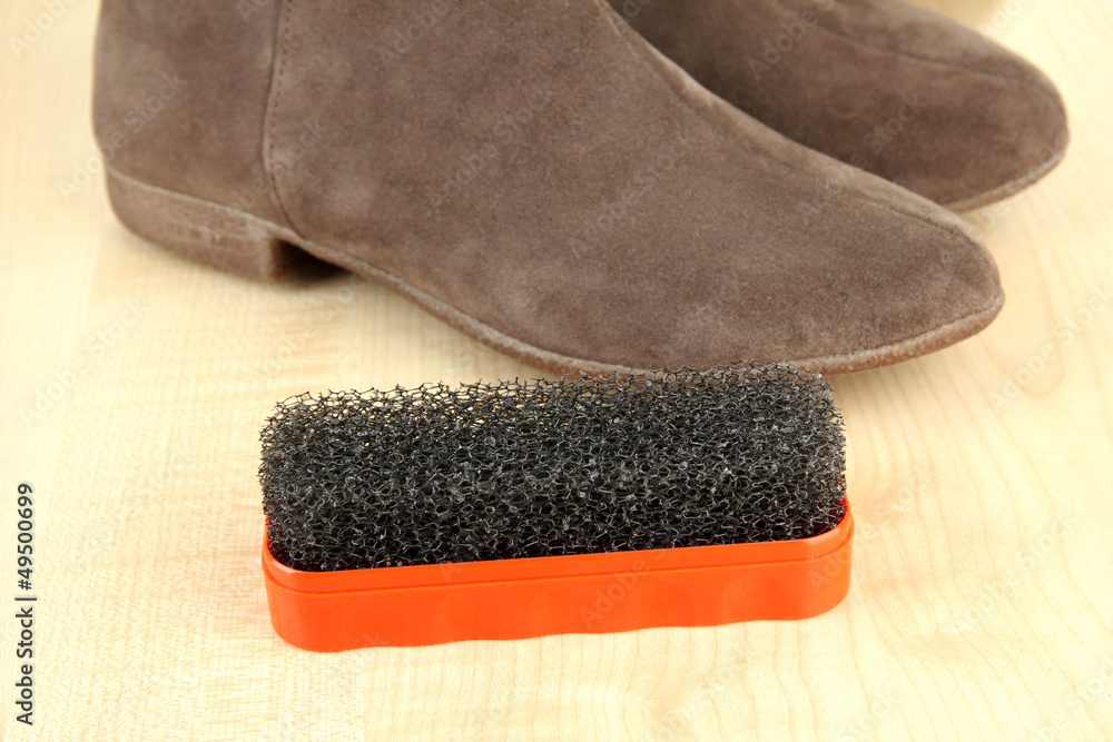 Brush for suede shoes, on wooden background