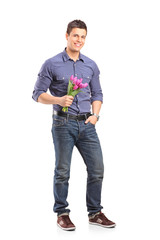 Sticker - Full length portrait of a smiling guy holding flowers and lookin