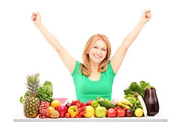 Sticker - Happy woman with raised hands posing with pile of fruits and veg