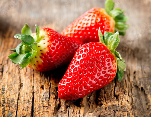 Naklejka nad blat kuchenny Strawberry over Wooden Background. Strawberries close-up