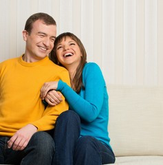 Happy couple sitting on sofa