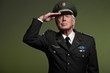 US military general wearing cap. Salutation. Studio portrait.