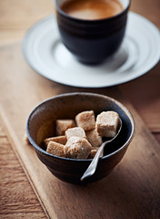 Wall Mural - Brown sugar cubes in a ceramic dish