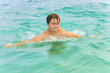 © travelview - boy enjoys swimming in the ocean