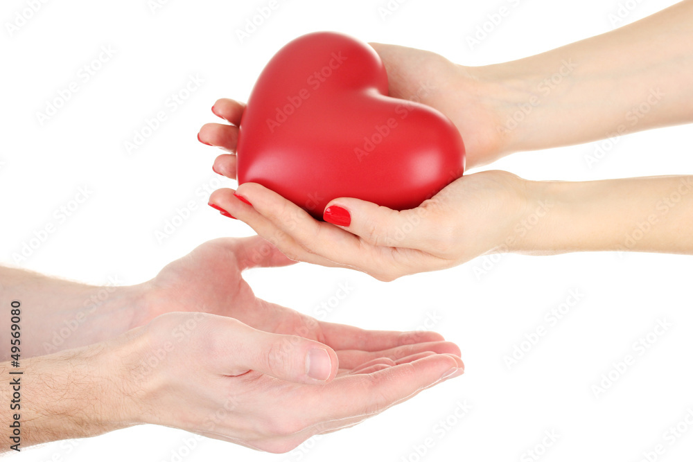 Red heart in woman and man hands, isolated on white
