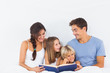 © WavebreakmediaMicro - Family sitting with a book