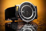 Fototapeta Psy - luxury watches with a leather strap on the orange background