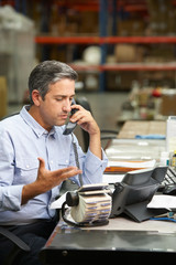 Wall Mural - Manager Working At Desk In Warehouse