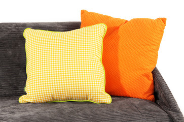 Colorful pillows on couch isolated on white