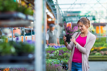 Young woman buying flowers at a garden center