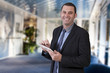 © pieropoma - Businessman using digital tablet in office