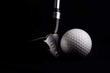 golf  club  with ball on black background