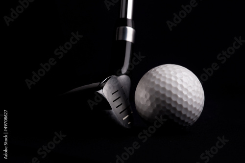 Board z aluminiowym obramowaniem Kij golfowy z piłką na czarnym tle