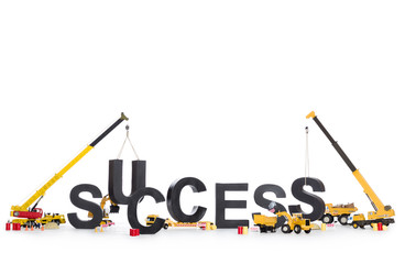 Build up success: Machines building success-word.