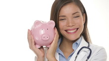 Medical Doctor Holding Piggy Bank Money Concept
