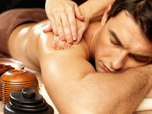 Naklejka na kafelki Man having massage in the spa salon