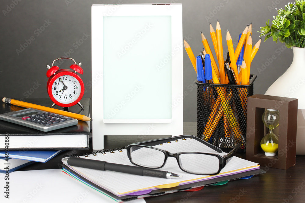 White photo frame on office desk on grey background