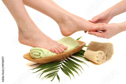 Fototapeta na wymiar Female feet receiving a massage, isolated on white