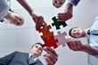 © .shock - Group of business people assembling jigsaw puzzle