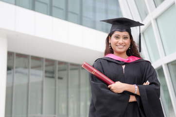 young indian female graduate with campus background