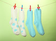 © Africa Studio - Colorful socks hanging on clothesline, on color background