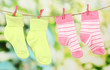 © Africa Studio - Colorful socks hanging on clothesline, on bright background