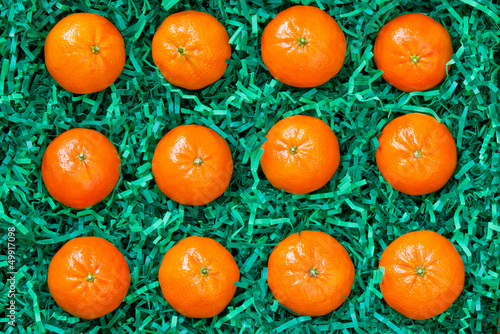 Fotografia, Obraz Fresh mandarins packed carefully, oranges background