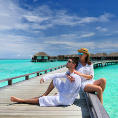 Sticker - Couple on a beach jetty at Maldives