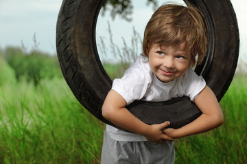 happy boy on swing outdoors