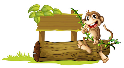 Wall Mural - A monkey sitting with a wooden signboard