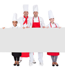 Wall Mural - Group of chefs presenting empty banner
