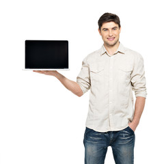 Wall Mural - man holds laptop with blank screen