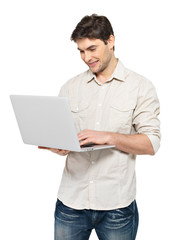 Portrait of young man with laptop  in casuals