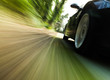 Side view of black car with heavy blurred motion.