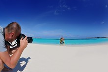 Photographer Taking Photo On Beach
