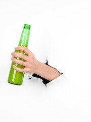 hand holding a beer bottle through a white paper