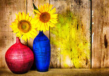 Colorful Vases With Sunflowers On A Wood Background