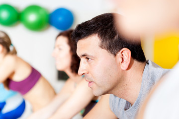 Group of people in the gym doing cardio training