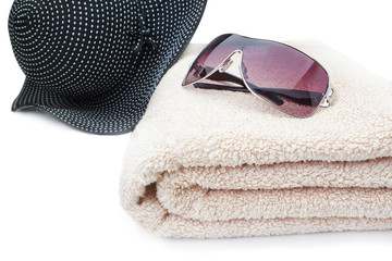 Glasses, a towel and a panama Beach Holiday. On a white backgrou