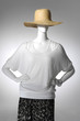 © CHEN, PAO-CHIN - female clothes in hat on a mannequin on light background