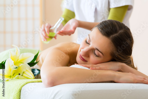 Naklejka na kafelki woman having wellness back massage in spa